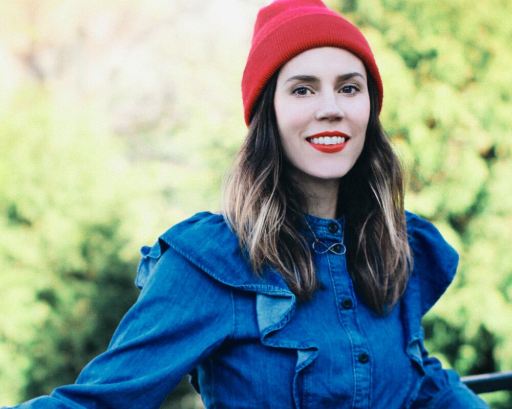 Jessica Lea Fleming smiling in a red toque and denim shirt